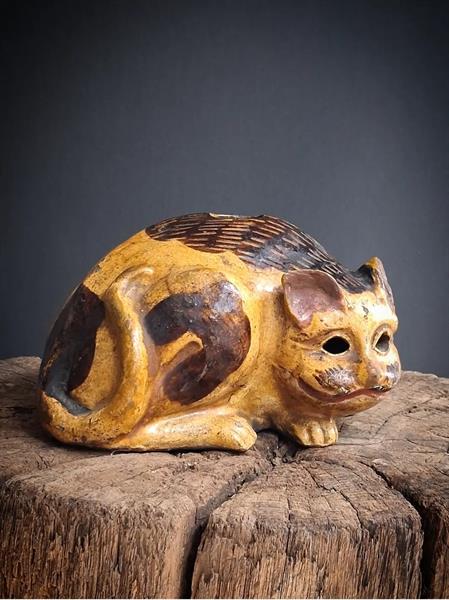 4. Crouching calico cat